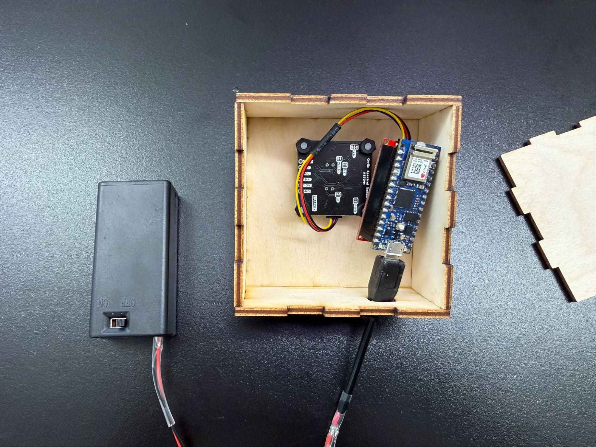photo of the inside of a sensor housing, showing the microcontroller and power components unmounted
