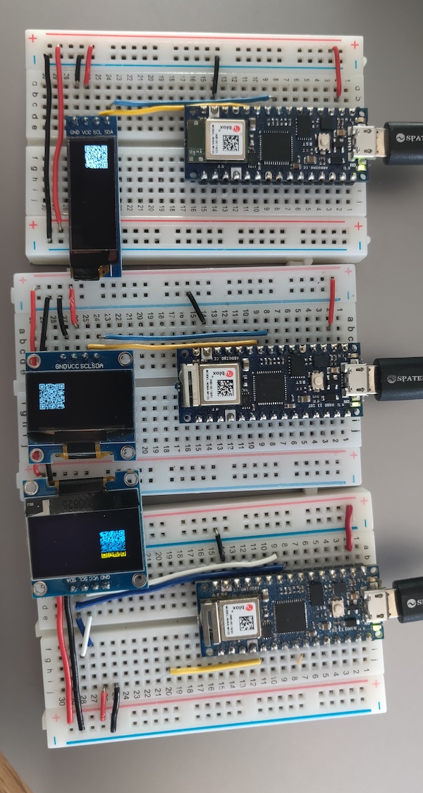 Photo of three SSD1306 OLED displays displaying QR codes